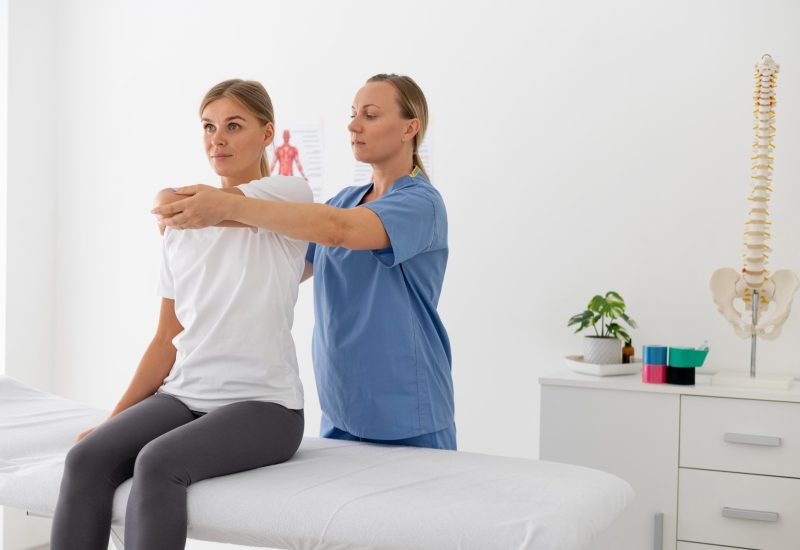 physiotherapist-helping-female-patient-her-clinic